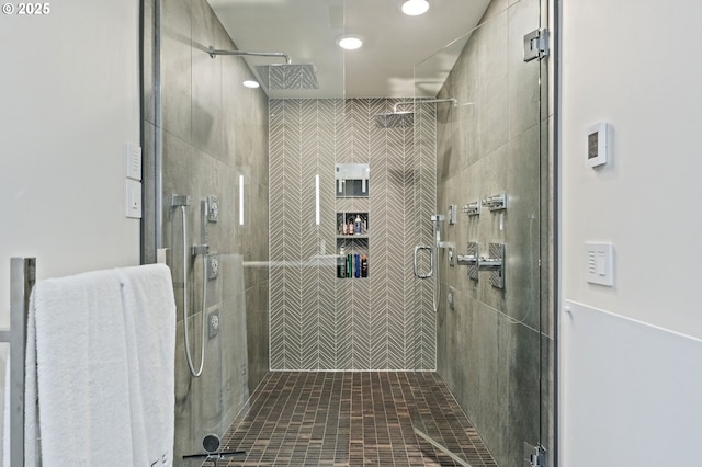 bathroom featuring a shower with door