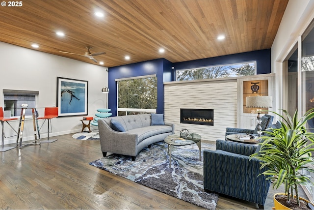 living area featuring wood finished floors, recessed lighting, ceiling fan, a tile fireplace, and wood ceiling