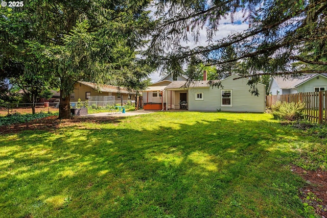 view of yard featuring a hot tub and a patio area
