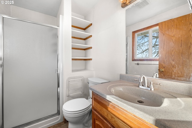 bathroom with vanity, toilet, and walk in shower