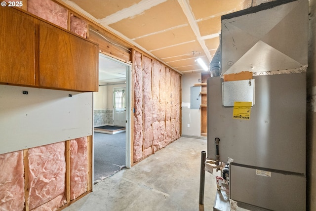 interior space featuring electric panel and heating unit