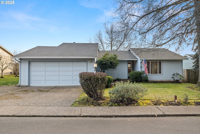 ranch-style home featuring a garage and a front lawn