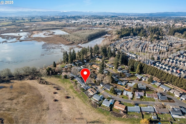 drone / aerial view with a water and mountain view