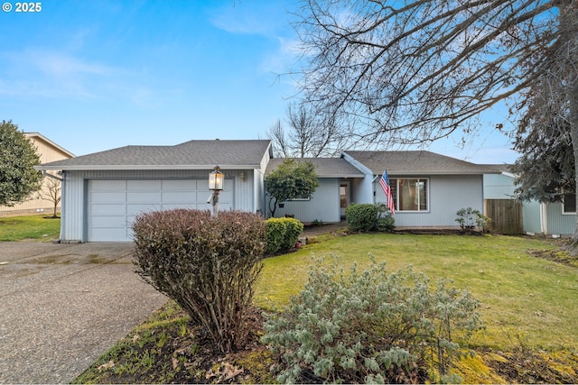 ranch-style home featuring a garage and a front lawn