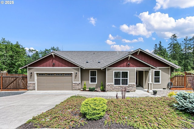 962 S 66th Pl, Springfield, OR 97478 - view of front of property with stone siding, a garage, driveway, roof with shingles, and a gate