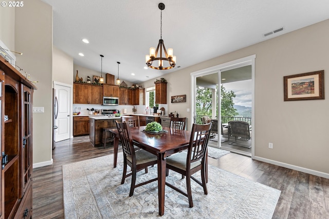 962 S 66th Pl, Springfield, OR 97478 - dining room featuring a chandelier, wood finished floors, baseboards, recessed lighting, and lofted ceiling