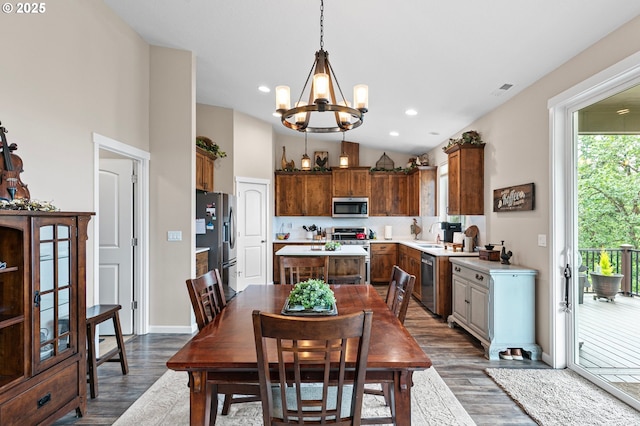 962 S 66th Pl, Springfield, OR 97478 - dining room with a chandelier, dark wood-type flooring, lofted ceiling, baseboards, and recessed lighting