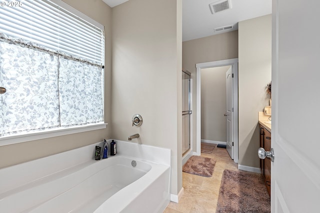 962 S 66th Pl, Springfield, OR 97478 - full bath featuring a garden tub, vanity, a shower stall, and healthy amount of natural light