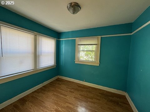 spare room with hardwood / wood-style flooring