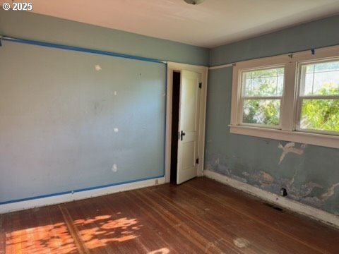 unfurnished bedroom featuring dark hardwood / wood-style floors