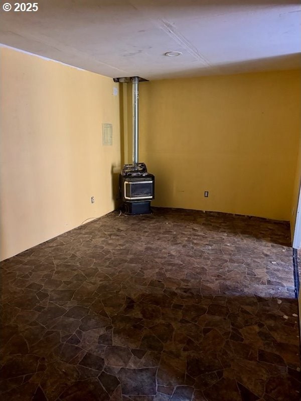 unfurnished living room featuring a wood stove