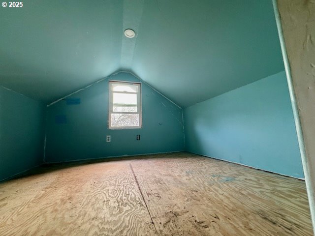 additional living space with vaulted ceiling