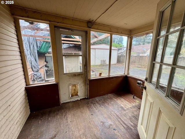 unfurnished sunroom with wooden ceiling