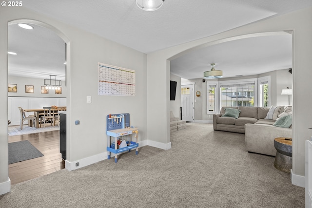 1366 Cramner St, Lafayette, OR 97127 - carpeted living area featuring arched walkways, baseboards, and a chandelier