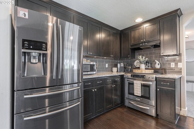 1366 Cramner St, Lafayette, OR 97127 - kitchen with stainless steel appliances, under cabinet range hood, dark wood-type flooring, light stone counters, and a textured ceiling