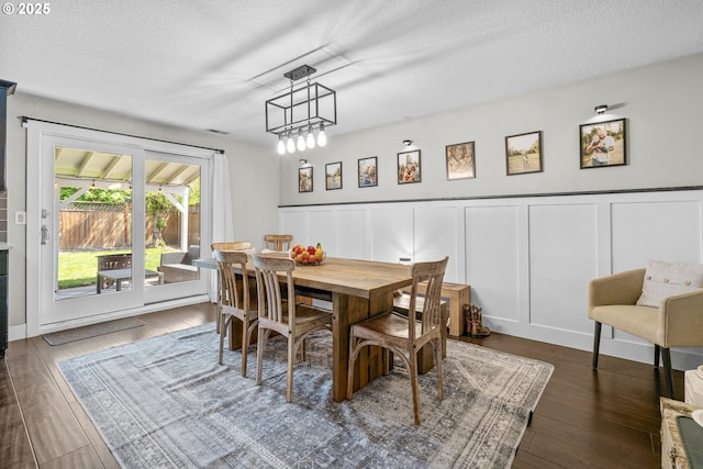 1366 Cramner St, Lafayette, OR 97127 - dining room featuring a decorative wall, a wainscoted wall, wood finished floors, and a textured ceiling
