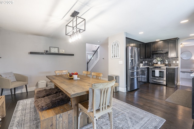 1366 Cramner St, Lafayette, OR 97127 - dining area featuring stairs, arched walkways, dark wood-style floors, baseboards, and recessed lighting