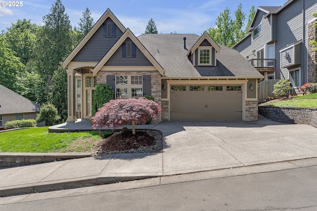 view of front of home with stone siding, an attached garage, driveway, a front lawn, and roof with shingles