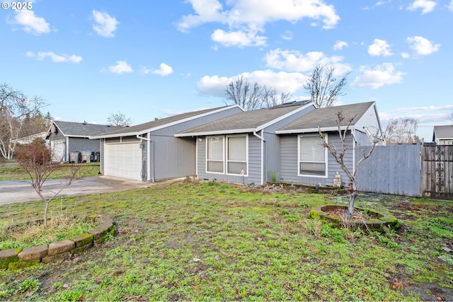 ranch-style home with a garage and a front lawn