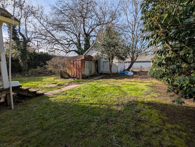 view of yard featuring a storage shed and an outdoor structure