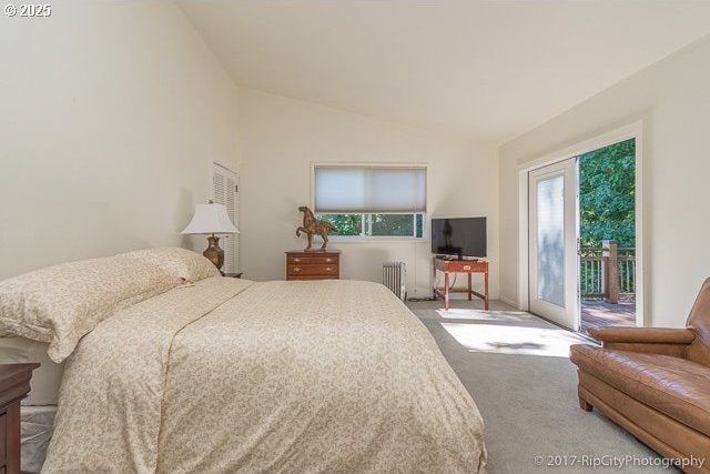 bedroom featuring access to exterior, radiator heating unit, lofted ceiling, and carpet