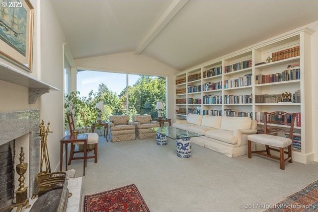 living area featuring vaulted ceiling with beams, a fireplace, and carpet floors