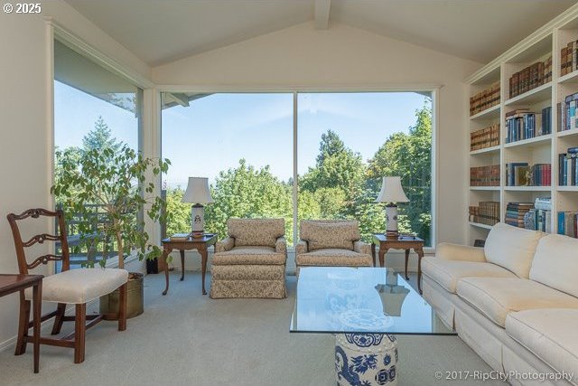 sunroom featuring lofted ceiling with beams