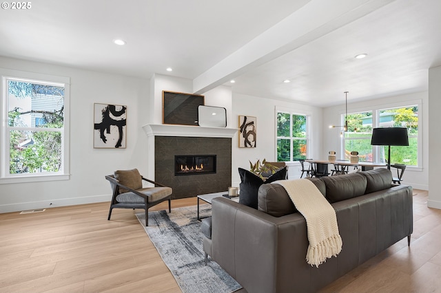 dining room featuring recessed lighting, baseboards, a notable chandelier, and light wood-style floors