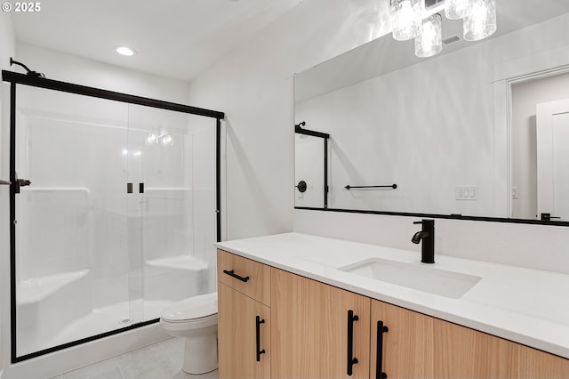 bathroom with vanity, toilet, tile patterned flooring, and a stall shower