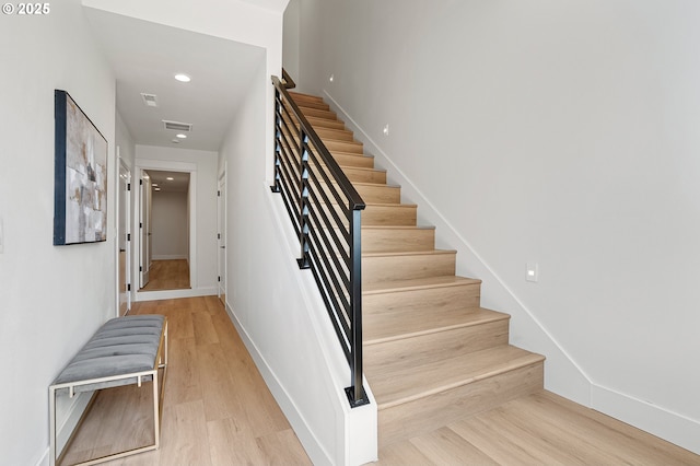 stairs featuring recessed lighting, baseboards, visible vents, and wood finished floors