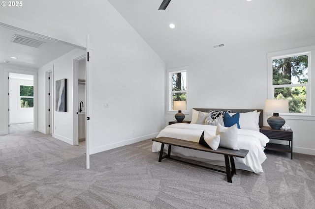 carpeted bedroom featuring visible vents and multiple windows