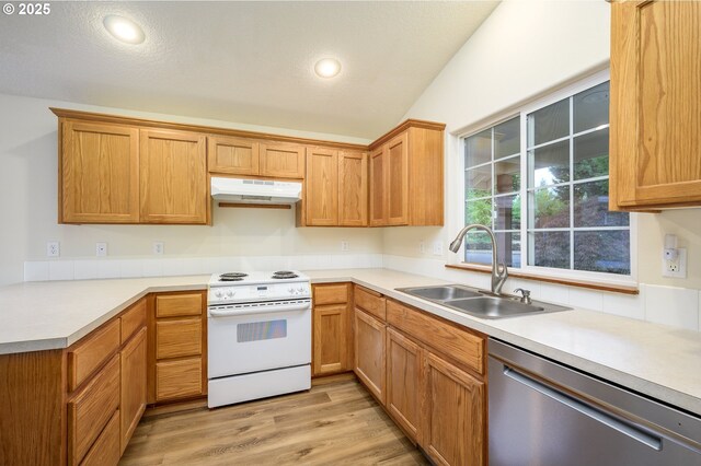 1301 E Sunset Dr, Newberg, OR 97132 - kitchen with white electric range, dishwasher, under cabinet range hood, a sink, and light countertops
