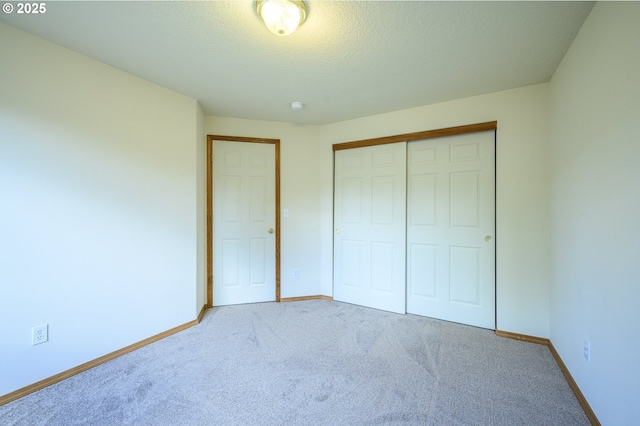 1301 E Sunset Dr, Newberg, OR 97132 - unfurnished bedroom featuring carpet, baseboards, a closet, and a textured ceiling