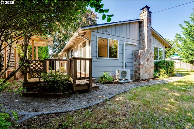 331 Limerick Ave, Eugene, OR 97404 - rear view of house featuring board and batten siding, a wooden deck, and a chimney
