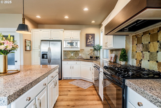 kitchen with stainless steel appliances, premium range hood, sink, and white cabinets