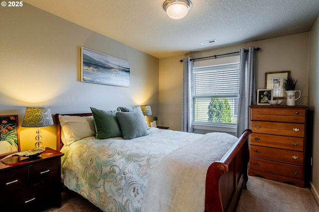 bedroom with carpet and a textured ceiling