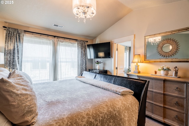 carpeted bedroom with a chandelier and vaulted ceiling