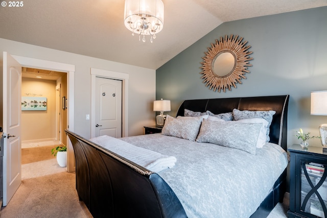 carpeted bedroom with lofted ceiling and a notable chandelier