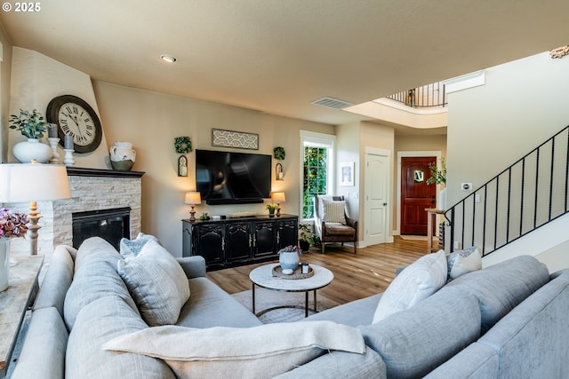 living room featuring a fireplace and light hardwood / wood-style flooring