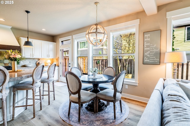 dining room with a chandelier and light wood-type flooring