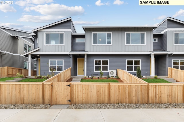 view of front of home with a fenced front yard, a gate, and board and batten siding