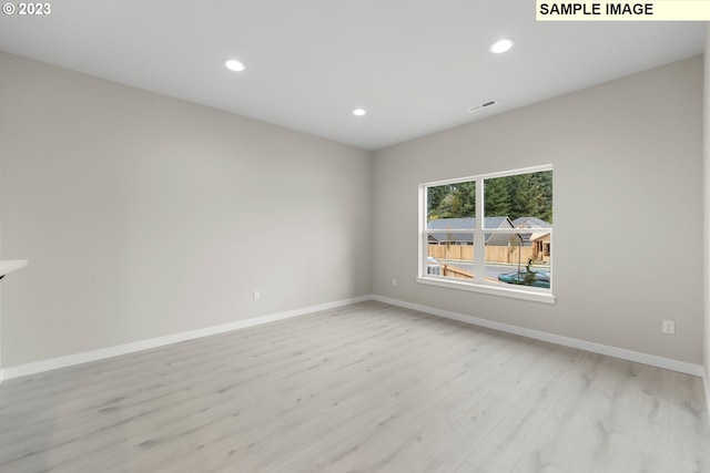 unfurnished room featuring light wood-style floors, recessed lighting, visible vents, and baseboards