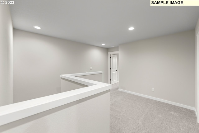 hall featuring recessed lighting, light colored carpet, and baseboards