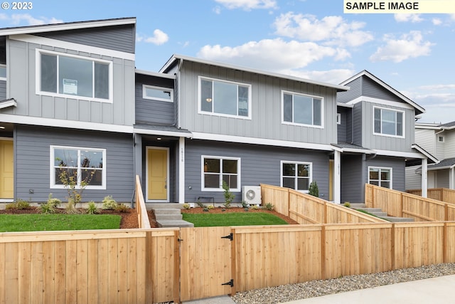 view of front of house featuring a fenced front yard, ac unit, and board and batten siding