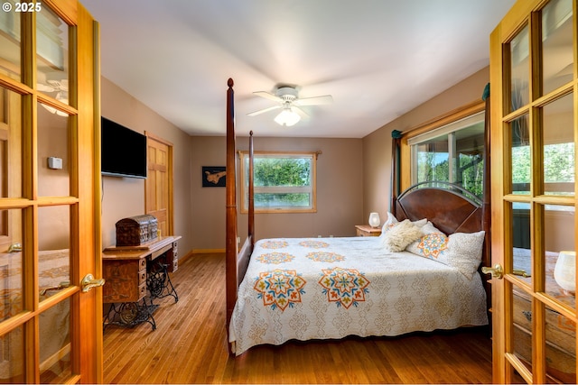 bedroom with wood-type flooring, french doors, and ceiling fan