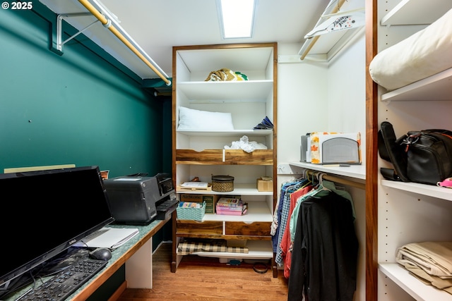 walk in closet featuring light hardwood / wood-style flooring