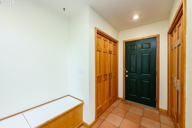 foyer entrance with light tile patterned floors