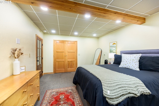 carpeted bedroom featuring a paneled ceiling