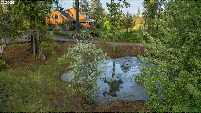 view of yard with a water view and a garage