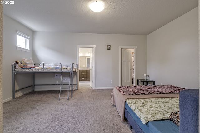 30942 NW Turel Dr, North Plains, OR 97133 - carpeted bedroom featuring ensuite bathroom, baseboards, and a textured ceiling